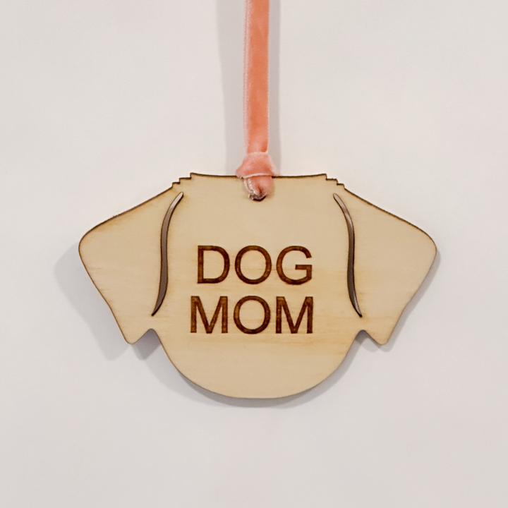 A wooden dog-shaped ornament with &