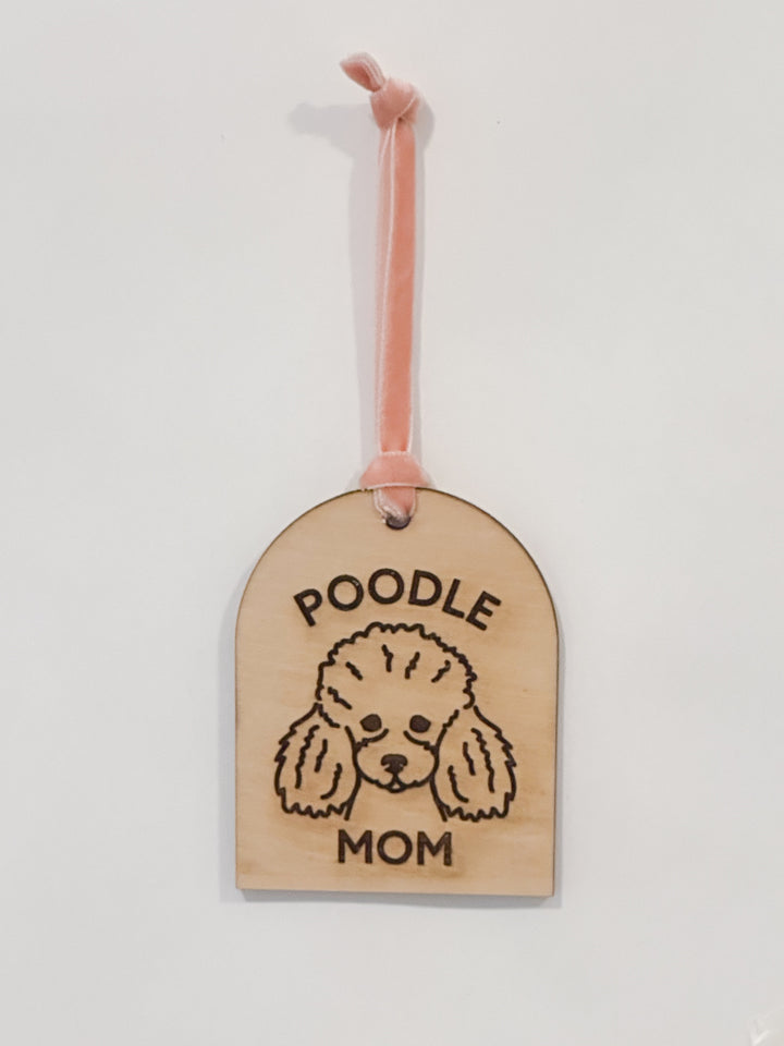 A wooden pet tag ornament engraved with &