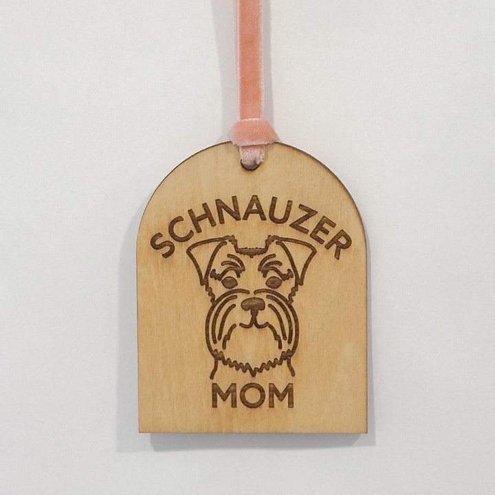 A personalized wooden luggage tag engraved with &