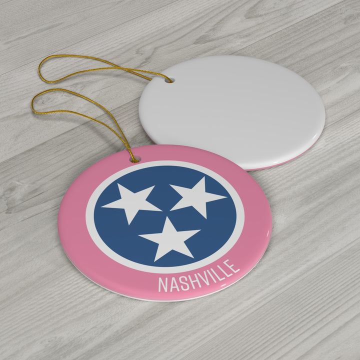 Southern-inspired pink, blue, and white tri-star ornament on a holiday tree, perfect for Nashville and Tennessee fans