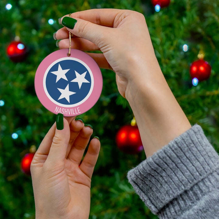 Southern-inspired pink, blue, and white tri-star ornament on a holiday tree, perfect for Nashville and Tennessee fans
